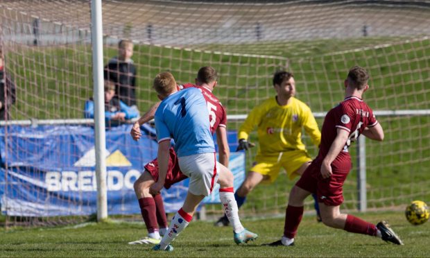 27 April 2024. Keith FC, Kynoch Park, Balloch Road, Keith,Aberdeenshire,AB55 5EN. This is from the Breedon Highland League game - Keith FC v Wick Academy FC. PICTURE CONTENT:- Wick's Ross Gunn (number 7) scores their second goal against Keith          CREDIT - JASPERIMAGE