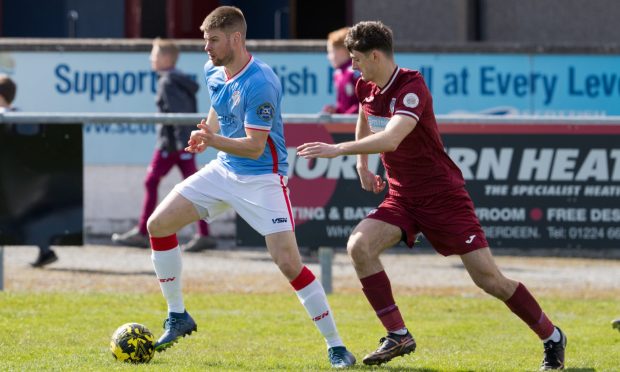 27 April 2024. Keith FC, Kynoch Park, Balloch Road, Keith,Aberdeenshire,AB55 5EN. This is from the Breedon Highland League game - Keith FC v Wick Academy FC. PICTURE CONTENT:-  Wick's Marc MacGregor, left, holds off Murray Addison of Keith.          CREDIT - JASPERIMAGE
