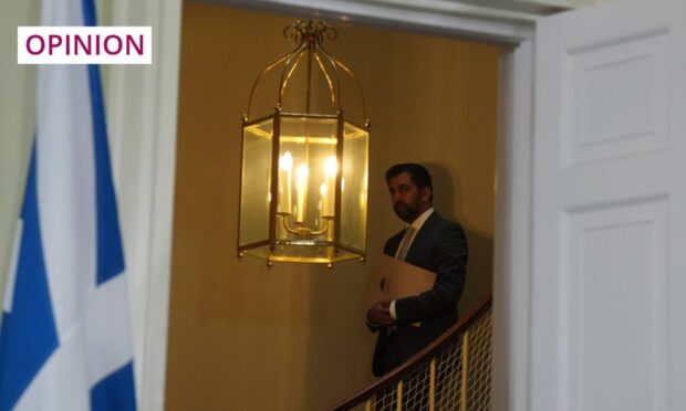 First Minister Humza Yousaf descends the stairs in Bute House, on his way to announce his resignation. Image: Andrew Milligan/PA Wire