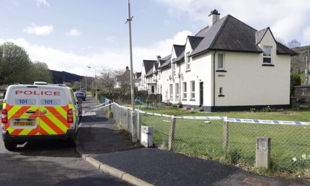 Police outside the property in Drumnadrochit. Image: DC Thomson.