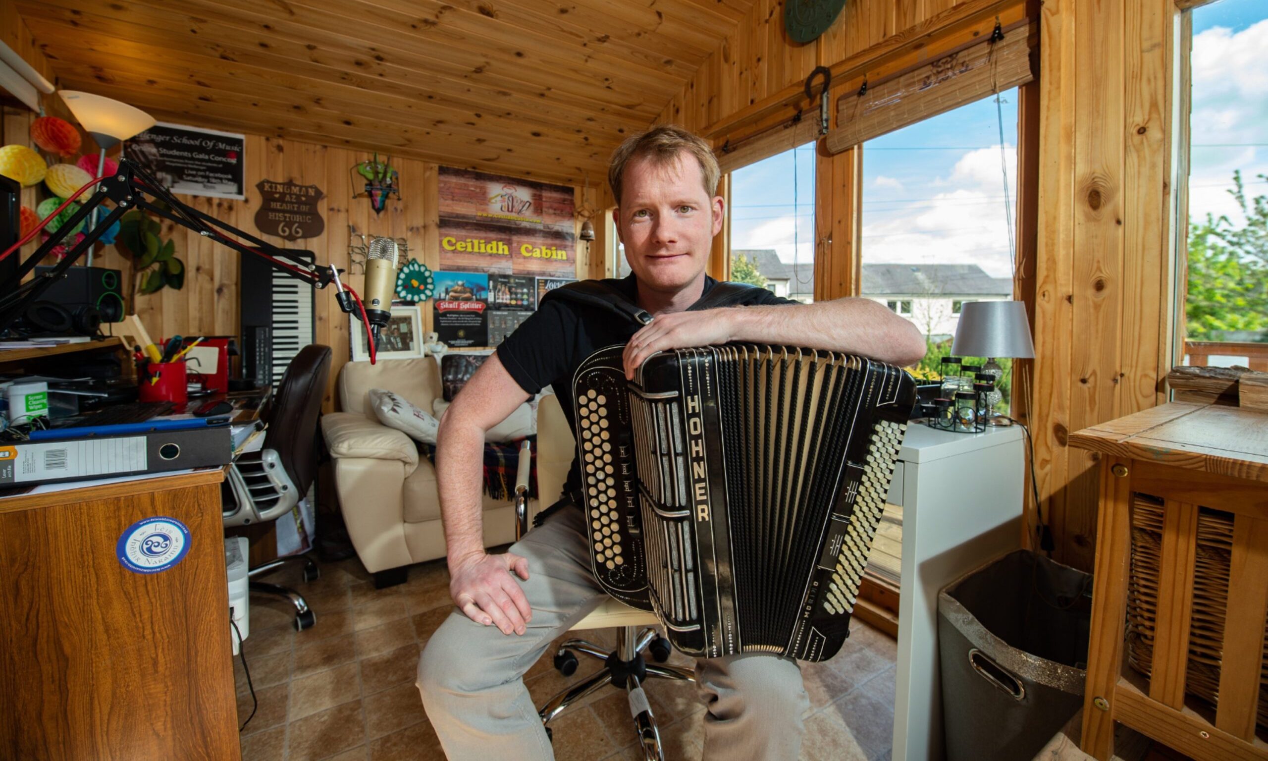 Graeme Mackay smiling while leaning on accordion.