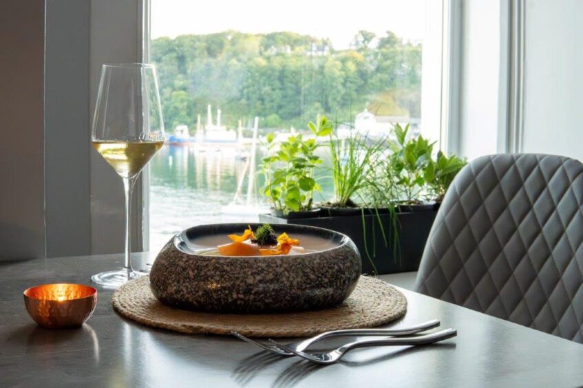 Shellfish bisque,one of the fine dining dishes by Ross Caithness. The bowl looks as if it has been carved from granite. 