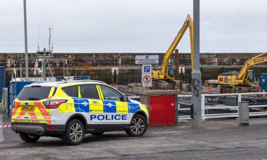 Police car sits at pier two at Buckie Harbour.