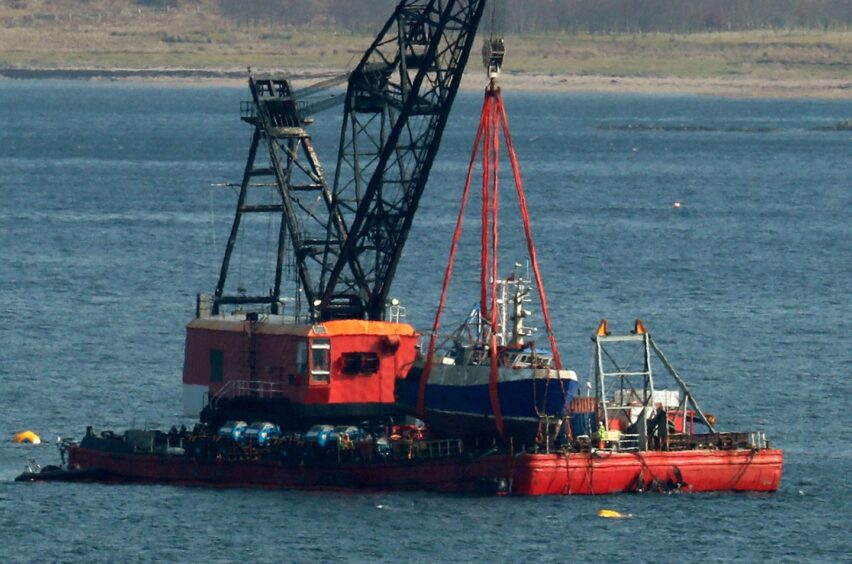 The Nancy Glen fishing trawler sits on a barge on Loch Fyne in Tarbert, Scotland after its recovery.  The capsized fishing boat sank on January 18 2018 and resulted in the loss of fishermen Duncan MacDougall and Przemek Krawczyk. 