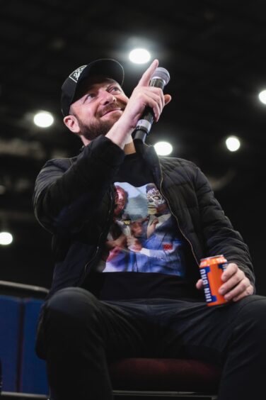 Marvel star Ross Marquand holds an Irn Bru.