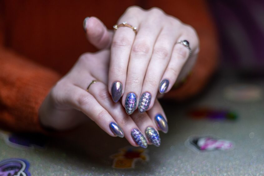 One of Katie Rudnicke's clients showing off her metallic nails.
