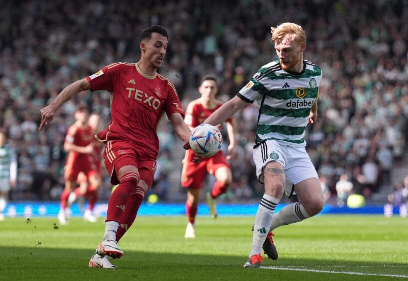 Celtic's Liam Scales (right) handles the ball, resulting in a VAR check, under pressure from Aberdeen's Bojan Miovski.