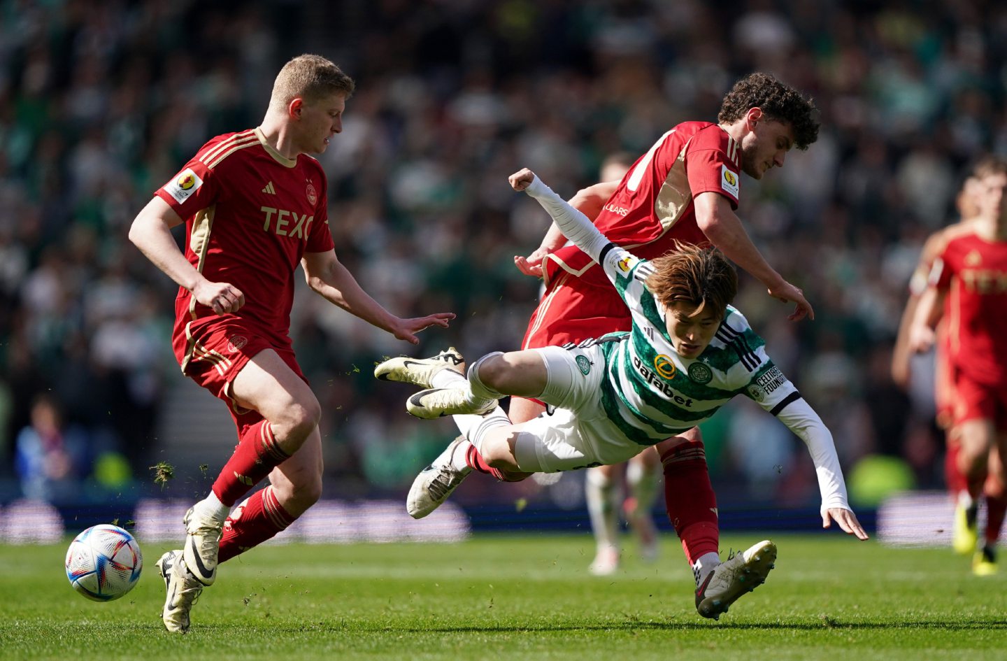 Celtic's Kyogo Furuhashi is challenged by Aberdeen's Dante Polvara (right) during the ScottishCup semi-final match at Hampden. Image: PA 