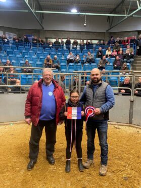 Judge Bill Cameron pictured with champion winner Steven Smith and his daughter Lily.