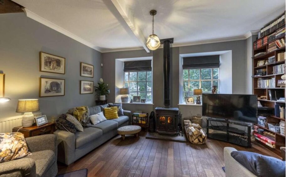Tillery House family room with wood burning stove and large bookcase on right wall