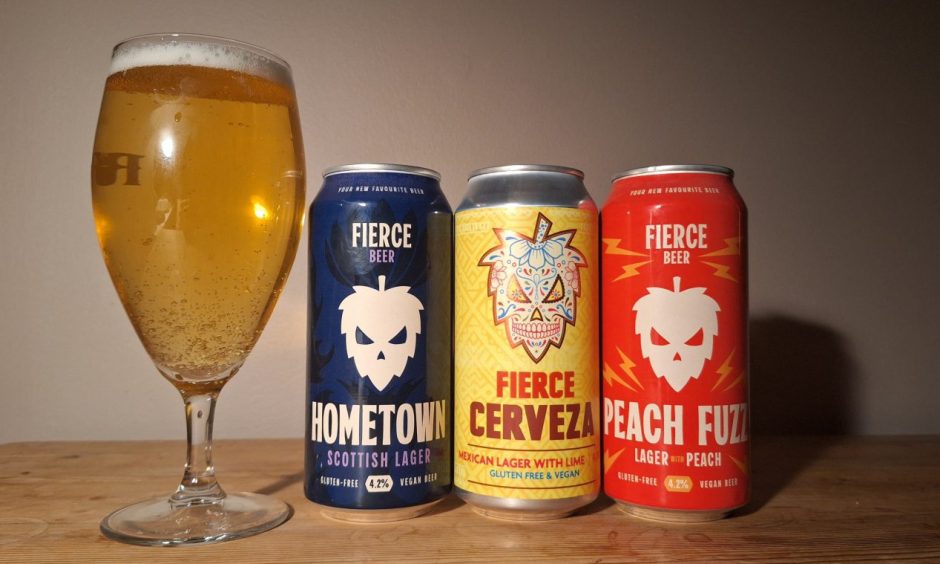 Three cans of Fierce Beer lager, and a glass full of one of the beers.
