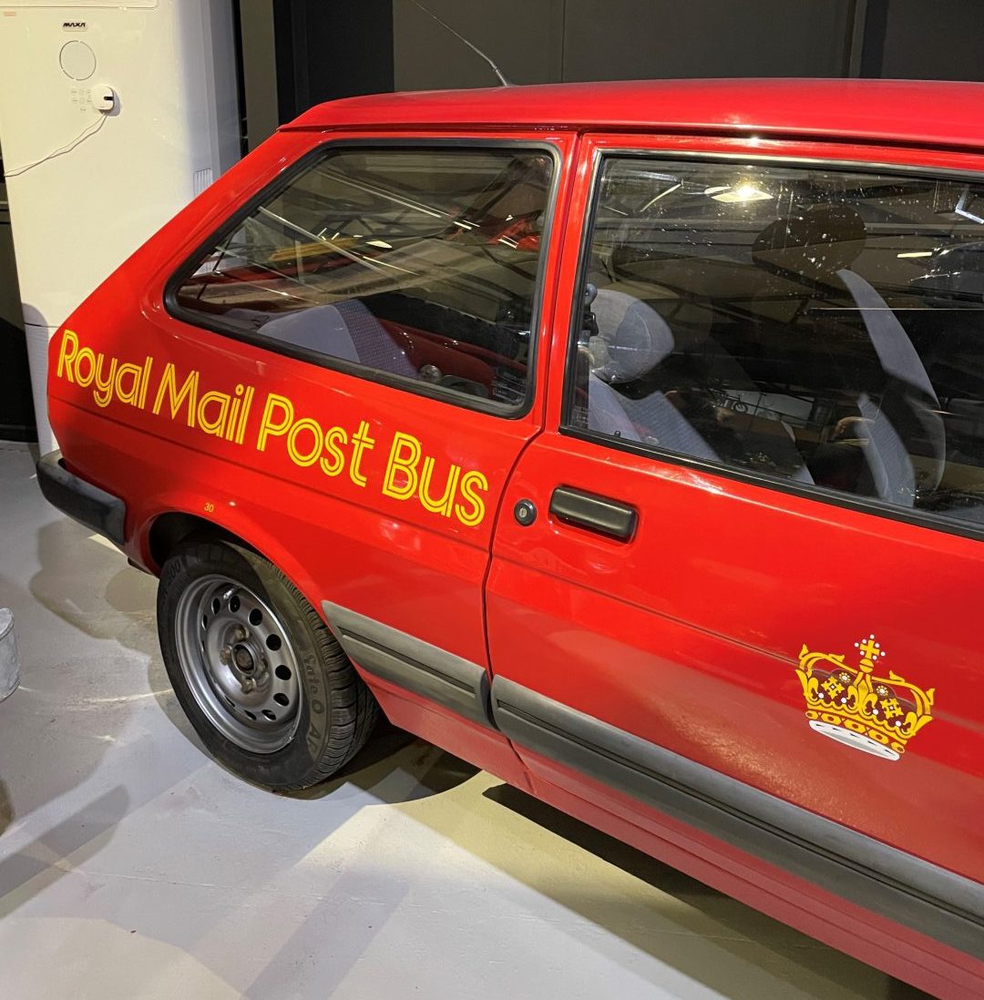 The red Fiesta Mailcar with Royal Mail Post Bus written on the side
