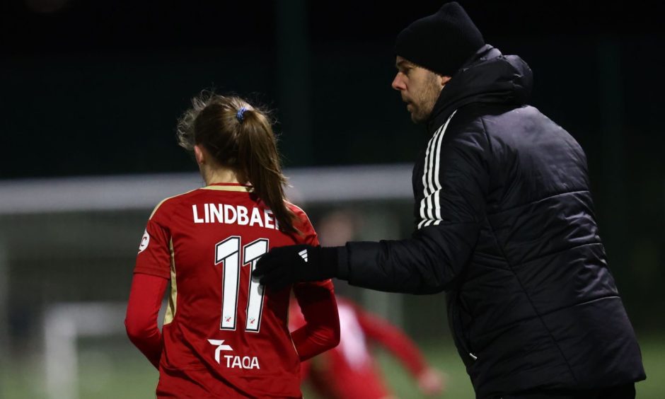 Adele Lindbaek receives instructions from Aberdeen Women manager Clint Lancaster.