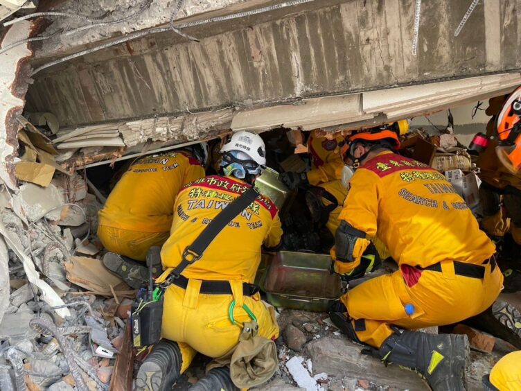 Rescuers searching in Taiwan earthquake damage.