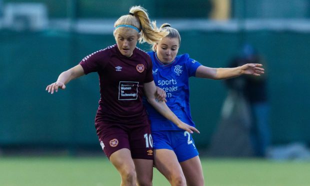Hearts forward Katie Lockwood, left, battles with Olivia McLoughlin of Rangers in a SWPL fixture at the Oriam.