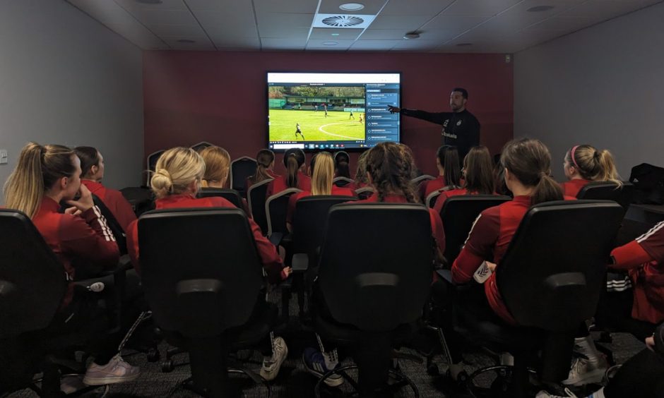 Aberdeen Women Clint Lancaster delivers an analysis session to his players ahead of the SWPL