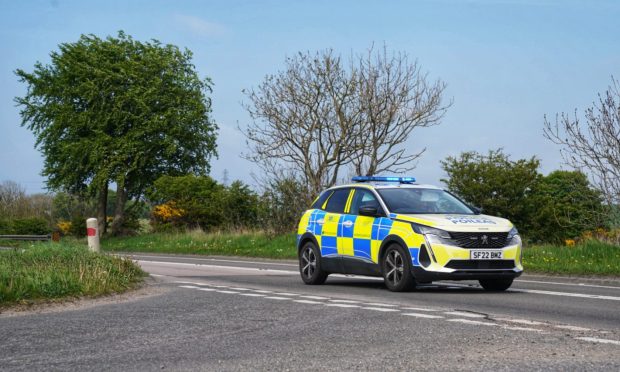 Police car blocks the A90 following a crash.