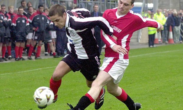 Ben Johnstone, number seven, heads in Rothes' goal against Lossiemouth. Pictures by Jasperimage