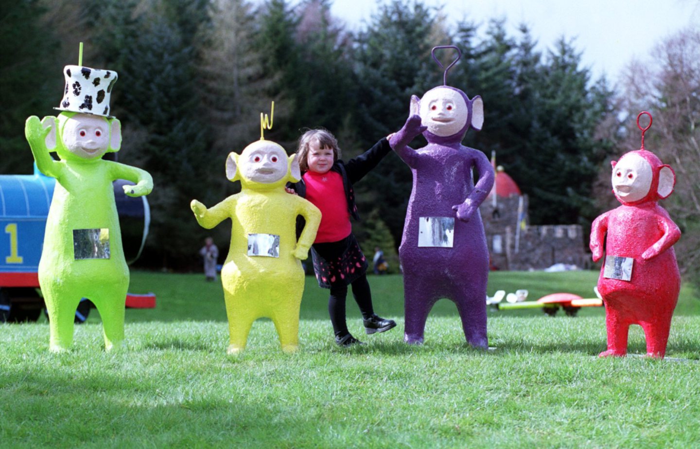 A child posing with the Teletubbies at Storybook Glen