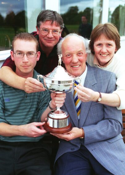 Winners of the Press and Journal Tee Talk Club Classic from Deeside Golf Club, gather round golf sports writer Colin Farquharson. From left, Mike Webster, Barton Henderson, and Sheena Bowman, after the presentation at Boat of Garten Golf Club.