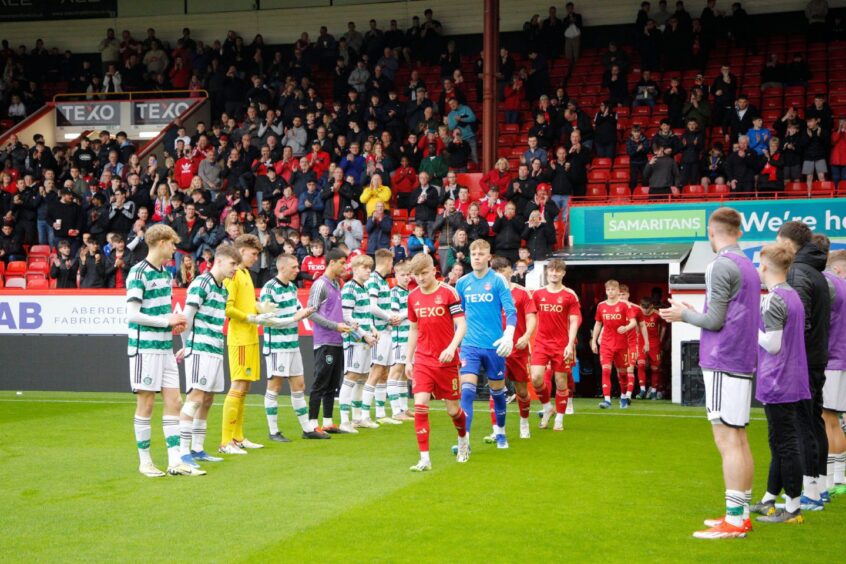 The Celtic players form a guard of honour for Aberdeen before the Club Academy Scotland Elite U18s League match at Pittodrie Stadium. Image: Shutterstock.