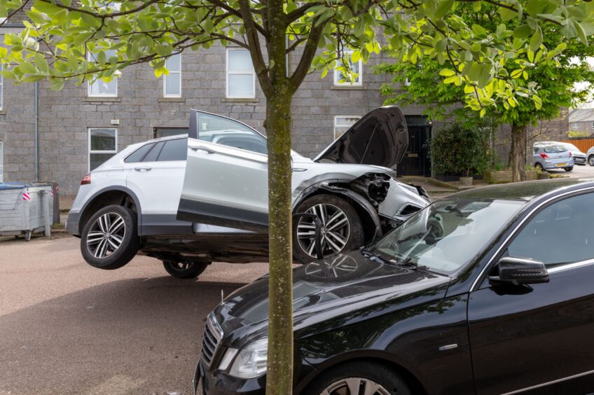 Car wheel on bonnet of parked car