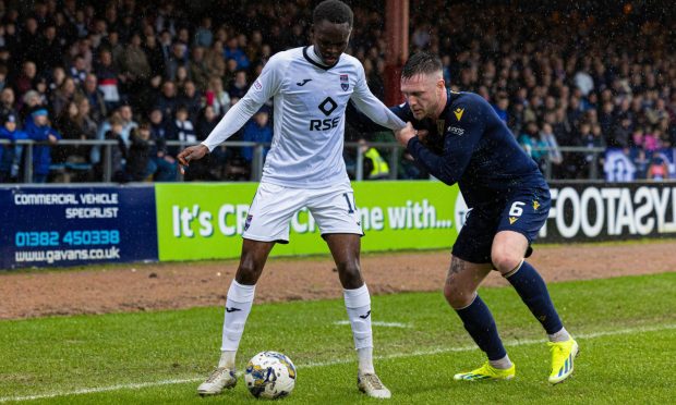 Ross County's Victor Loturi (left) is delighted to have played his part in keeping the Dingwall club in the Premiership. Image: SNS