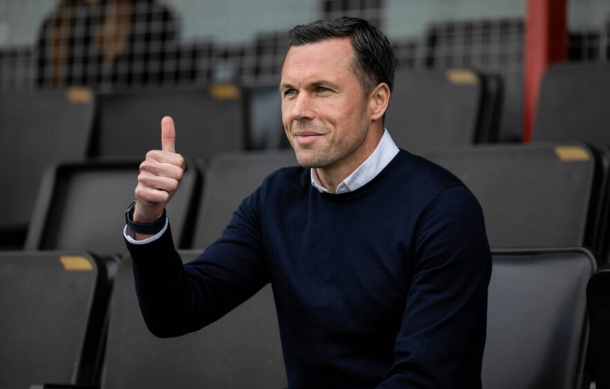 Ross County interim boss Don Cowie giving a thumbs up from the stands