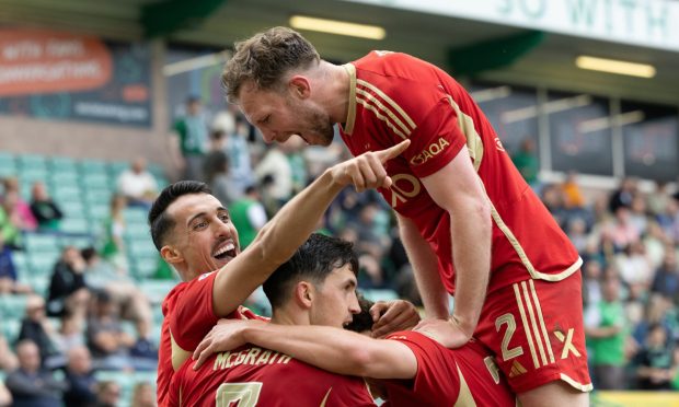 Aberdeen's Bojan Miovski celebrates with Nicky Devlin as he scores to make it 3-0 against Hibs at Easter Road. Image; SNS