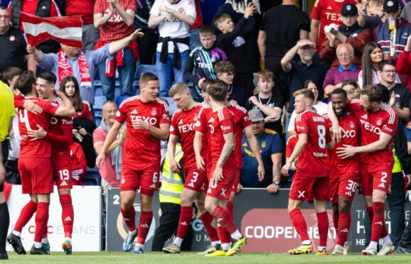 Aberdeen's Jamie McGrath celebrates with teammates after scoring to make it 2-1 against Ross County. Image: SNS.