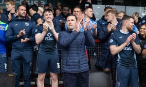 Don Cowie leads the celebrations after leading Ross County to Premiership safety. Image: SNS