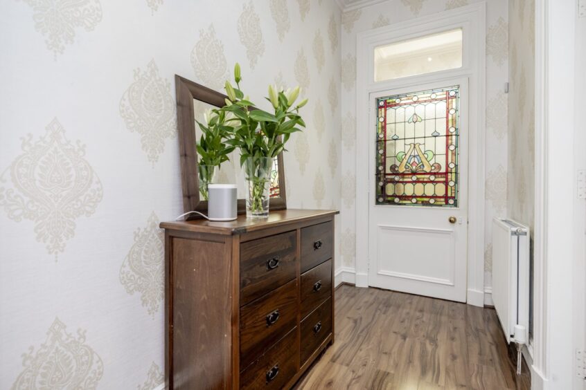 Entrance featuring stained glass window inside renovated apartment in Aberdeen's west end.