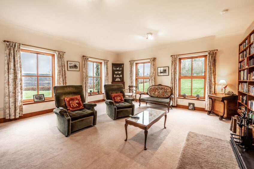 Spacious lounge area with large windows at the Highland home