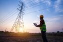 standing engineer watching an electric power station