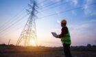 standing engineer watching an electric power station