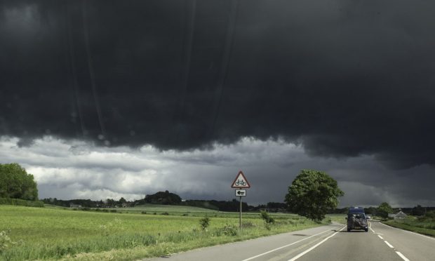 It's the second warning for thunderstorms this week; a dark cloud over Elgin before the rain set in yesterday. Image Jason Hedges/DC Thomson.