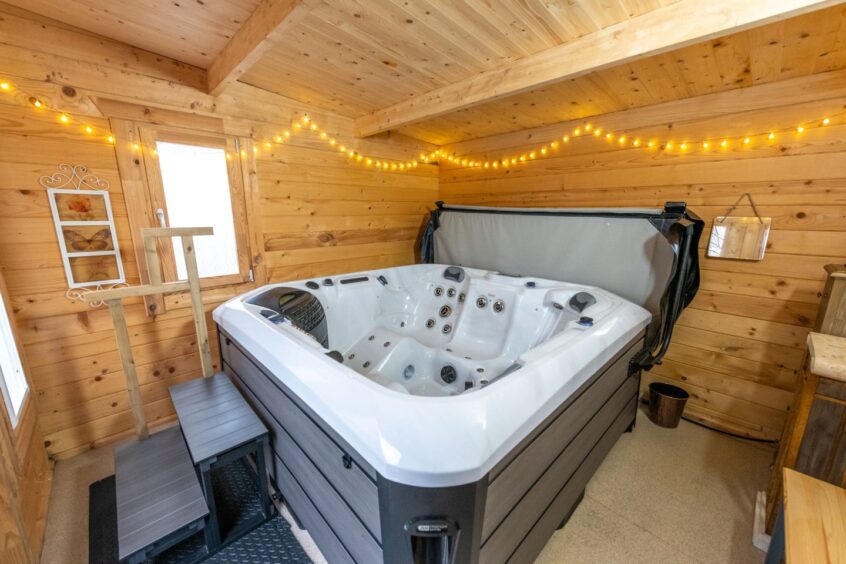 A hard wood hot tub cabin with a six-seater hot tub at the renovated Stonehaven home