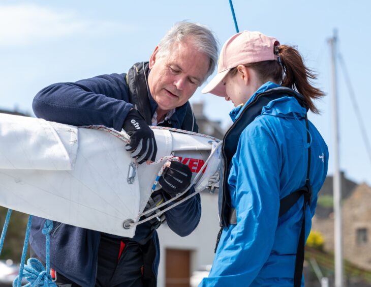 Bob Maycock and Polina Khodareva get the sailing boat prepared. Image: Brian Smith/Jasperimage.