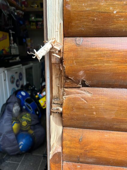 Wood splinters on the door frame following a break-in.