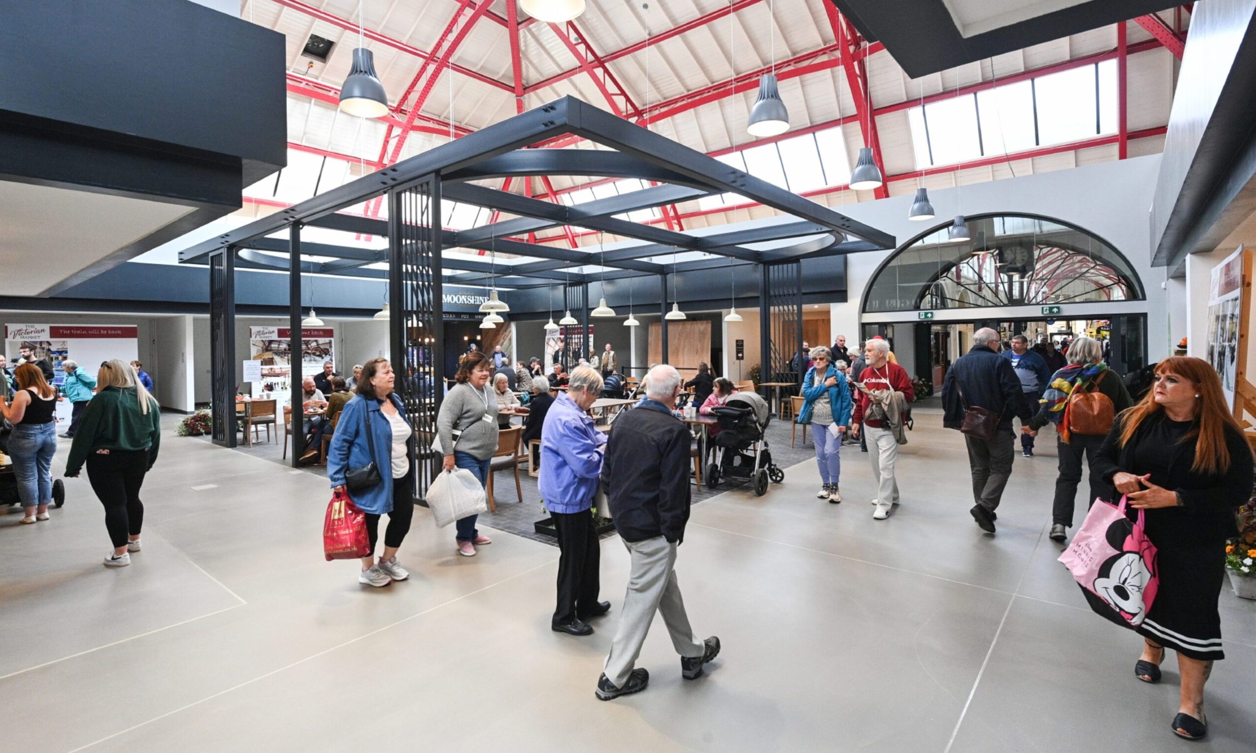 People gather to eat and shop in the market's food hall.