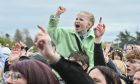 Child cheering above the crowd at MacMoray.