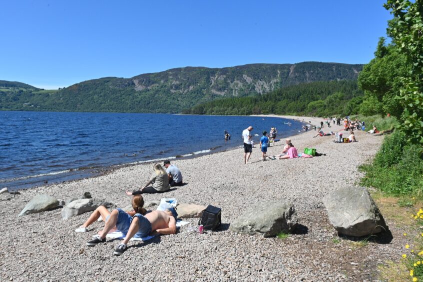 Holidaymakers on Dores Beach, near Inverness
