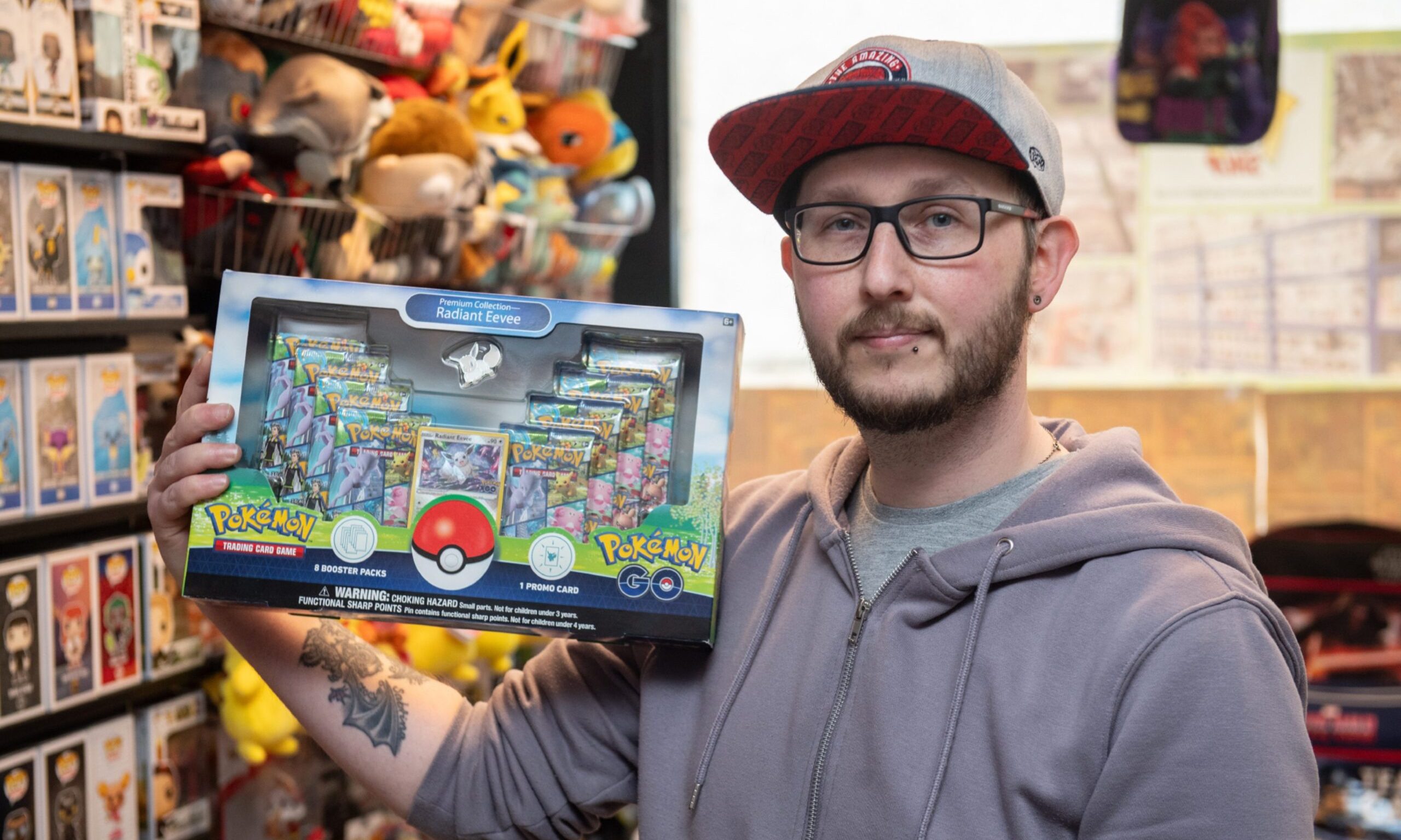 Peter Ralston holding Pokemon box. 