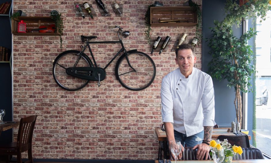 Marius Puscas inside Planta with bike on the wall behind.