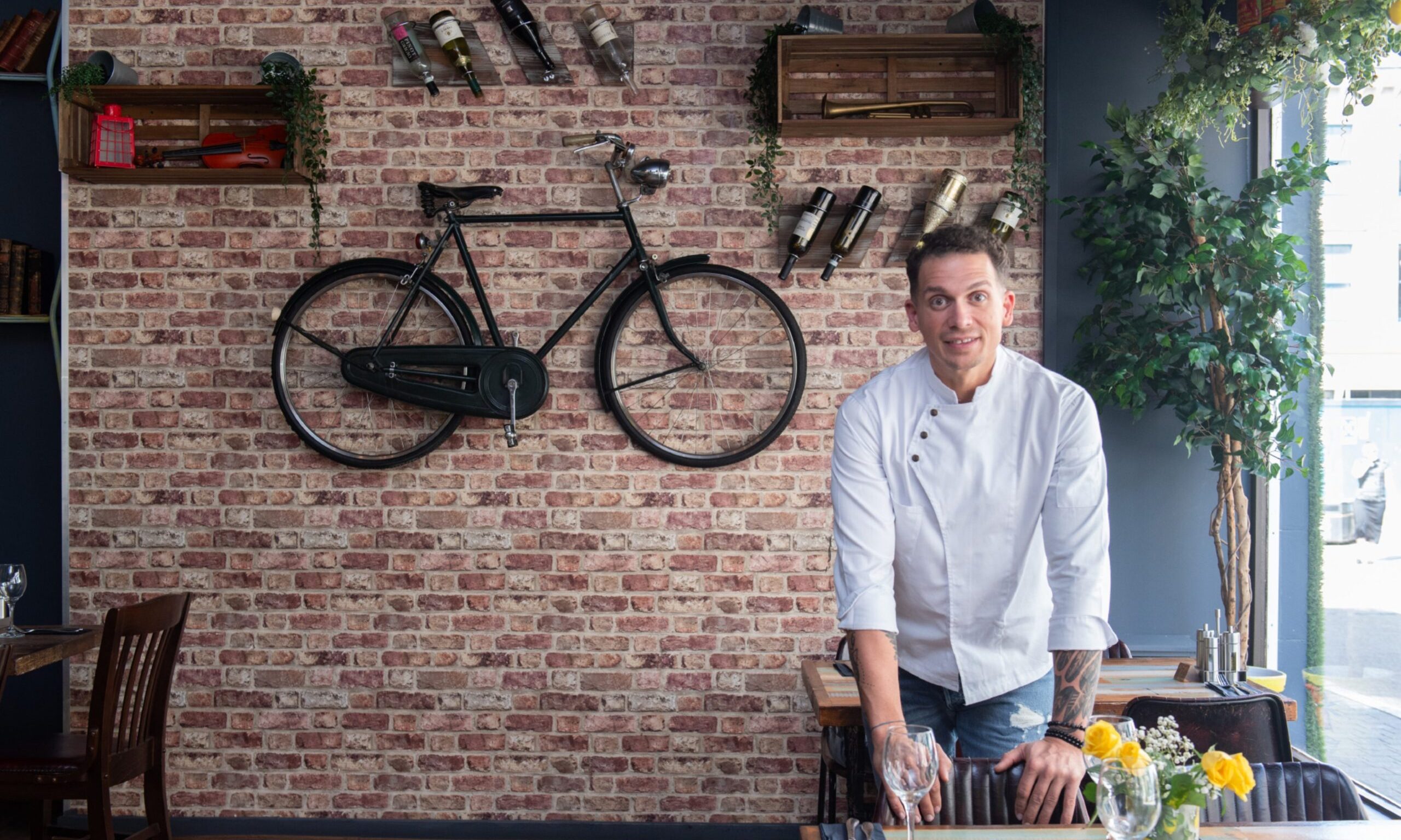 Marius Puscas inside Planta with bike on the wall behind. 