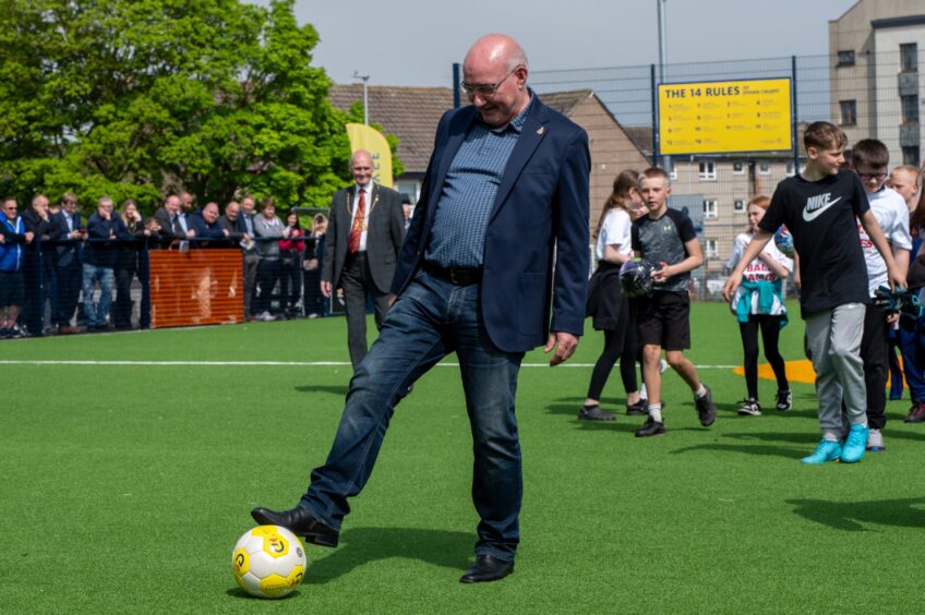 Don's legend Willie Miller kicking a football on new Cruyff Court. 