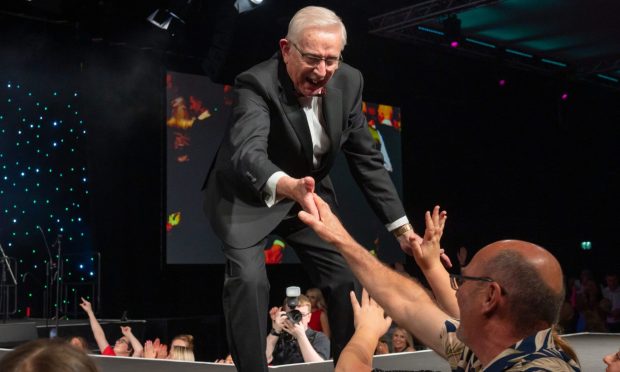 Brave's oldest model, 90-year-old Alastair Henderson from Bucksburn, works the crowd at P&J Live on Thursday night. The Friends of Anchor charity fashion show went off with a bang. Image: Kenny Elrick/DC Thomson