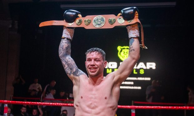 Dean Sutherland raises the Celtic super-welterweight title after beating Sion Yaxley. Image: Kath Flannery/DC Thomson