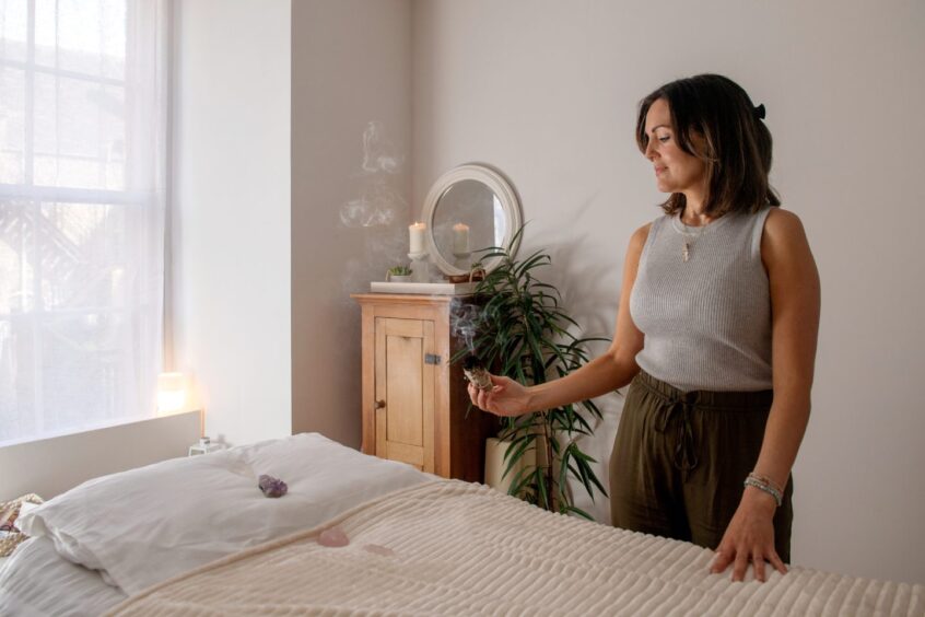 Relaxing room at Breathing Space Studio with lit candle and burning sage.