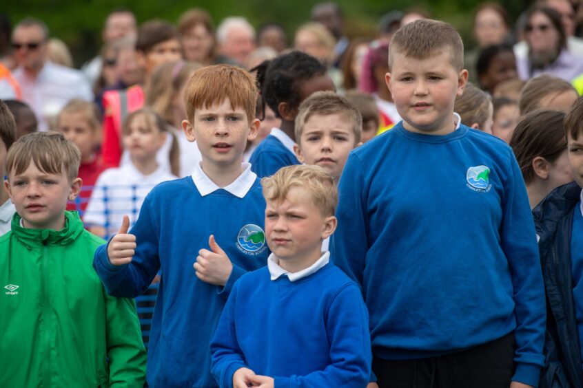 School pupil gives two thumbs up during Aberdeen Big Sing.